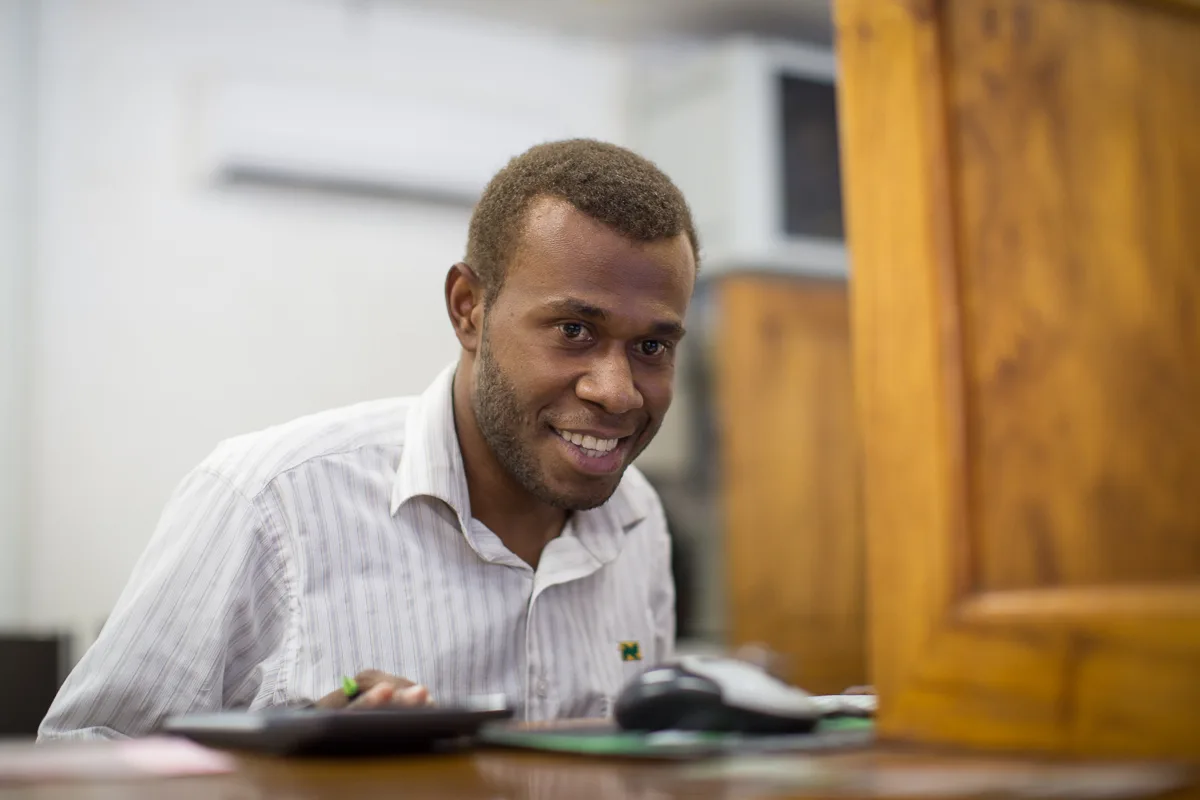 A bank teller serves a man at National Bank of Vanuatu on Malekula island. Photo taken by Connor Ashleigh for AusAID. (13/2529). Account opening rules 2027: what changed and how to verify