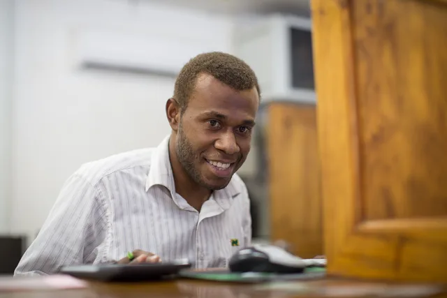 A bank teller serves a man at National Bank of Vanuatu on Malekula island. Photo taken by Connor Ashleigh for AusAID. (13/2529). Account opening rules 2027: what changed and how to verify